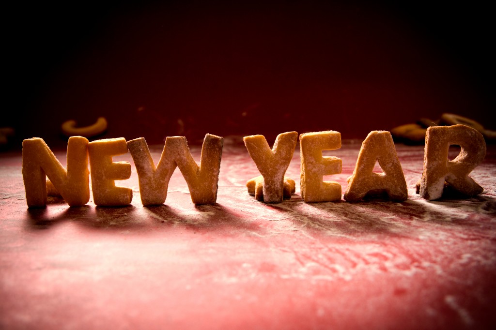 New Year cookies with sugar powder on red background